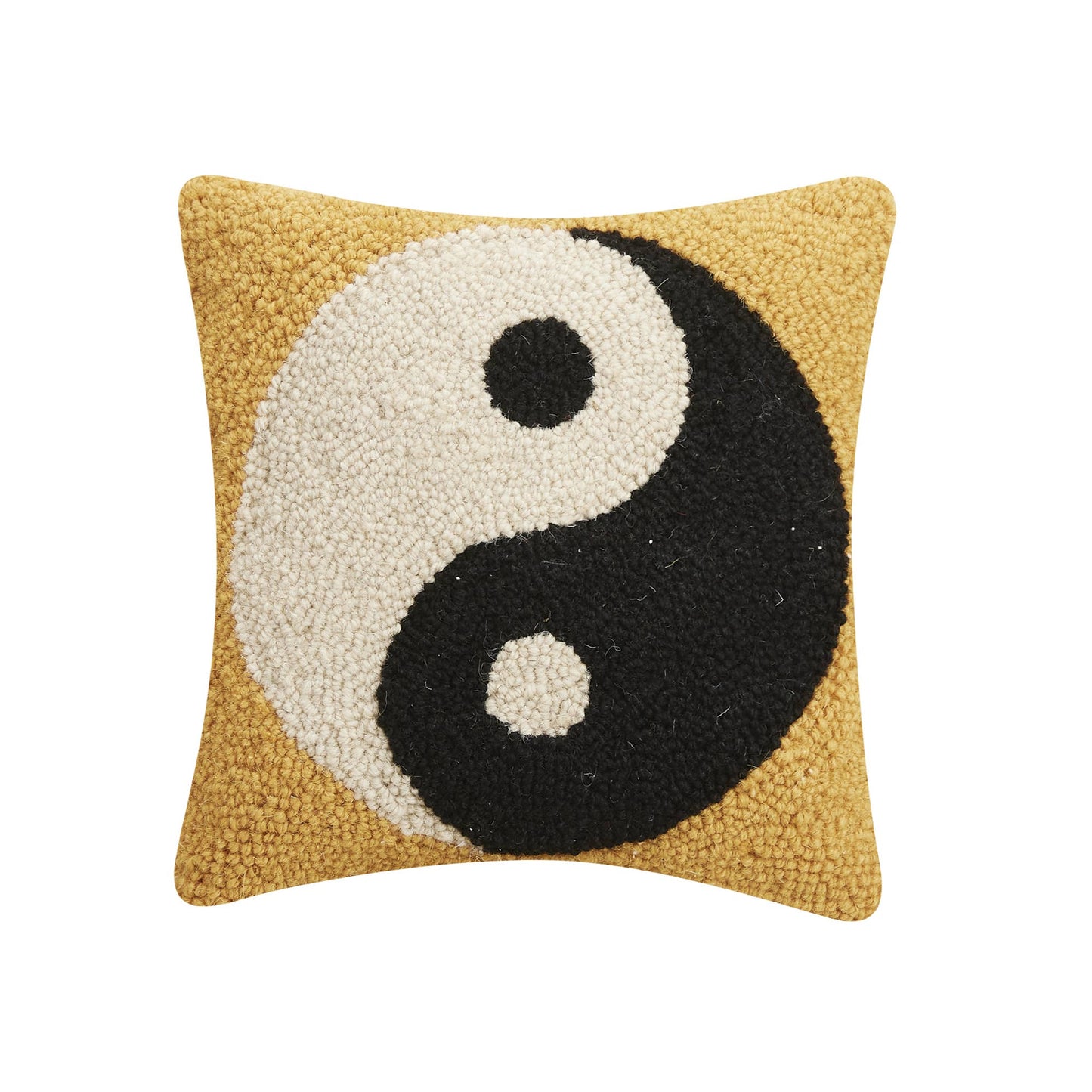 Peaceful accent piece with black and white yin/yang symbol against soft yellow wool fabric
