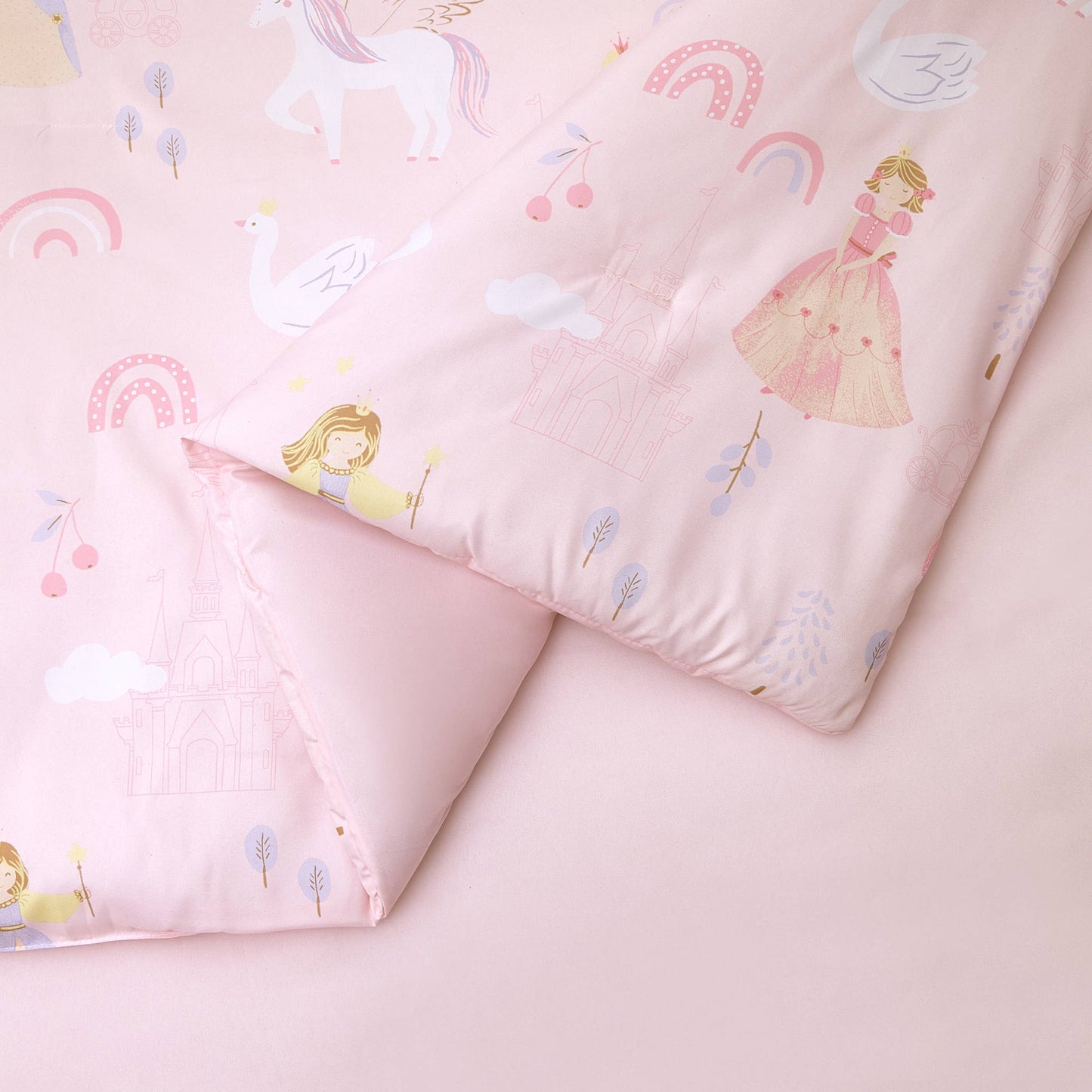 Fairytale inspired comforter adorned with magical princess design across soft pink comforter