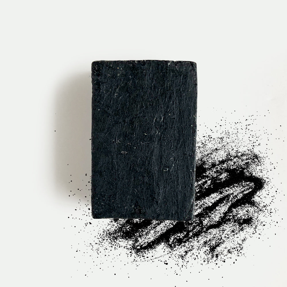 Activated charcoal beauty bar soap with natural ingredients to cleanse and exfoliate precious skin.