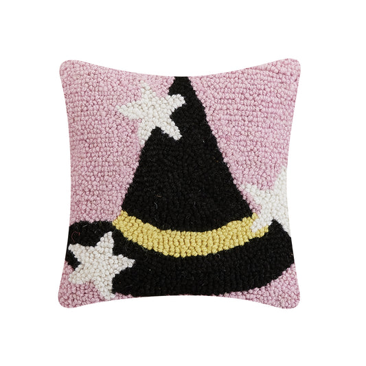 Pink decorative wool pillow with a black and gold witch hat with white twinkling stars