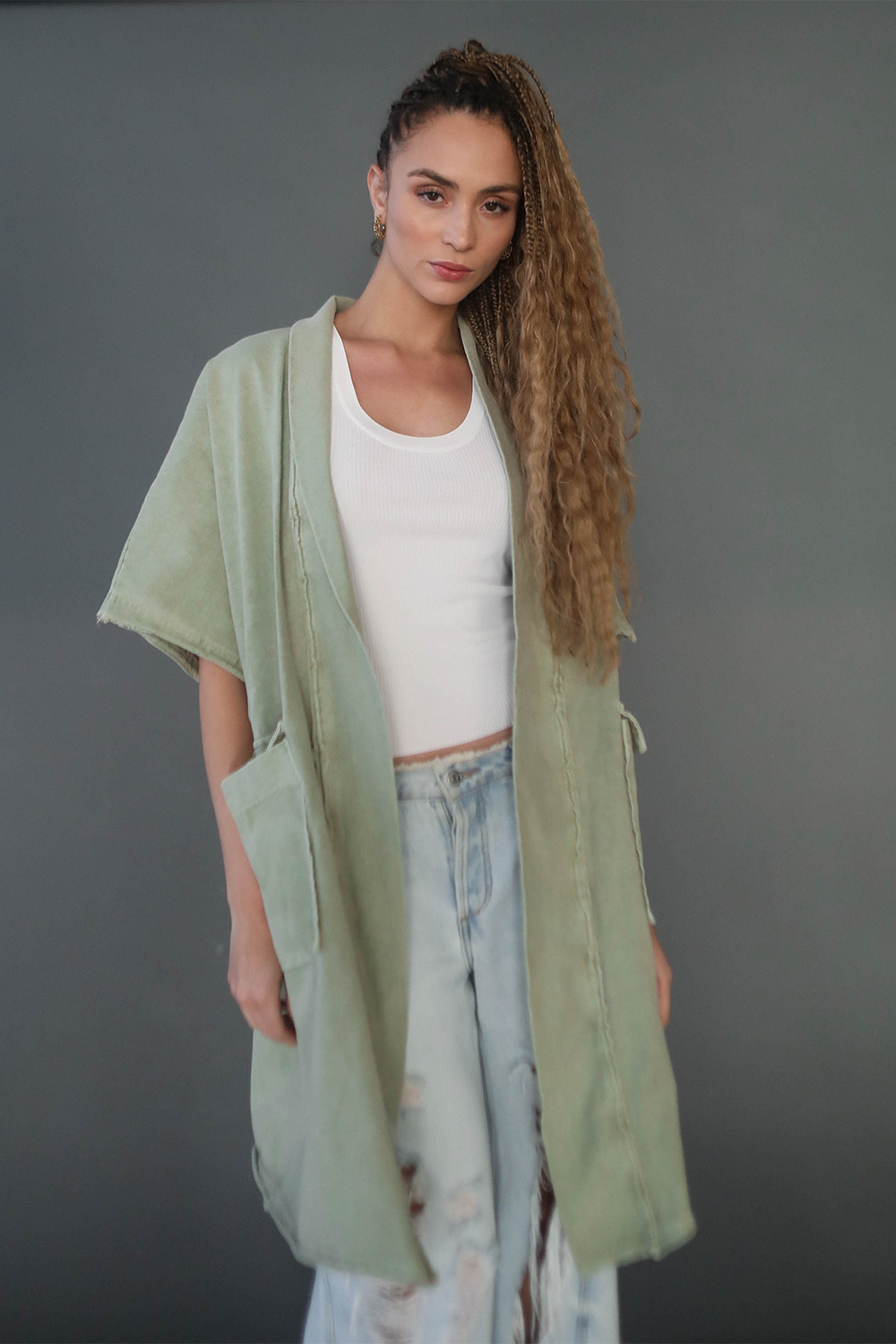 Flowy, moss colored oversized knee-length boho jacket made from cotton with oversized sleeves and large square outer pockets.