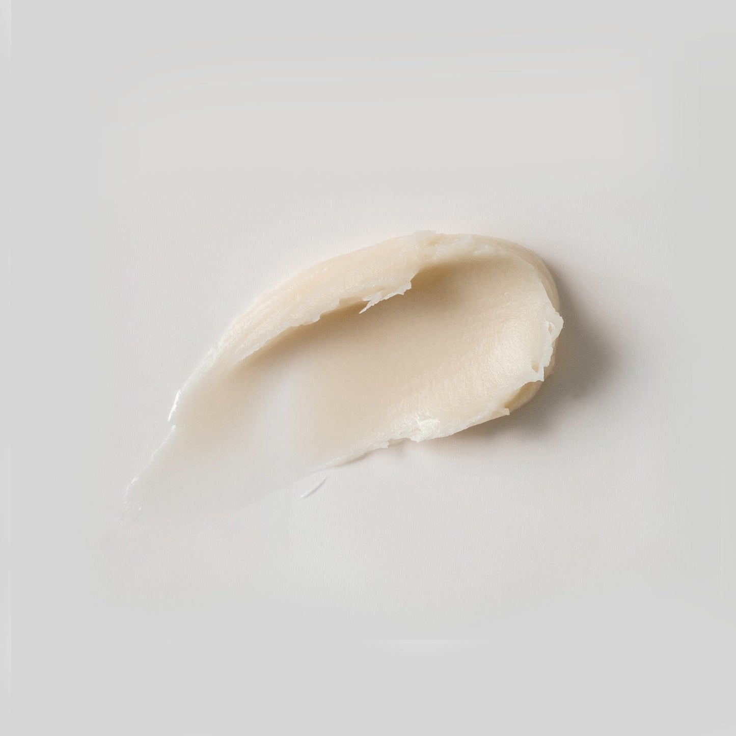 Creamy lip balm spread with natural ingredients and warm vanilla scent