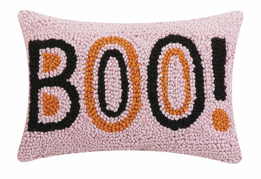 Decorative wool hooked pillow with black and orange 'BOO!' text on a pink background