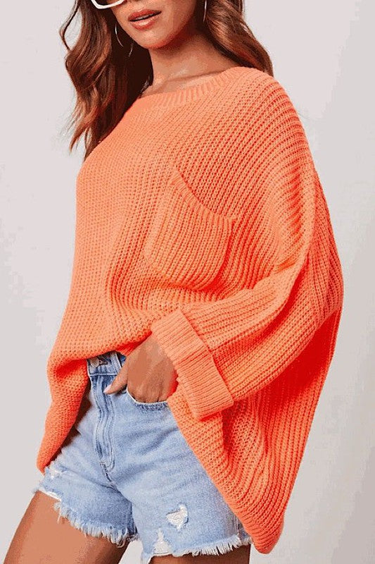 Light and bright orange oversized knit sweater with pocket.