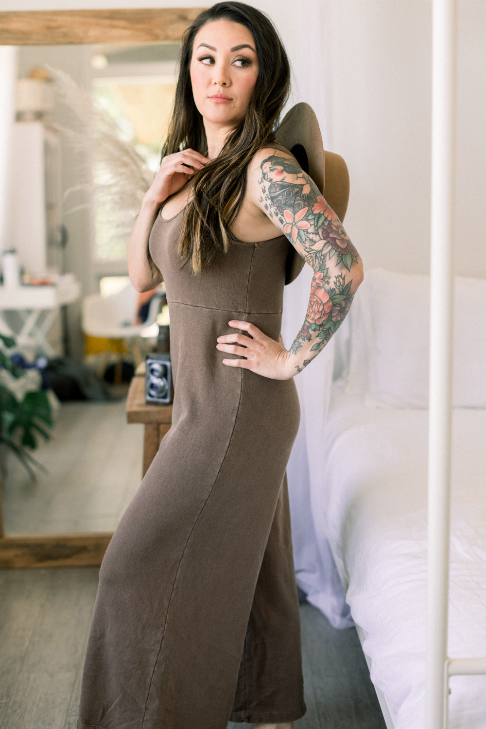 Ash brown color for vintage look against organic cotton. Sleeveless jumpsuit with waist-defining seam and wide legs for flexibility.