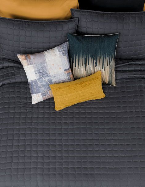 Aerial view of bed with black embroidered Luxus Centauro Quilt.