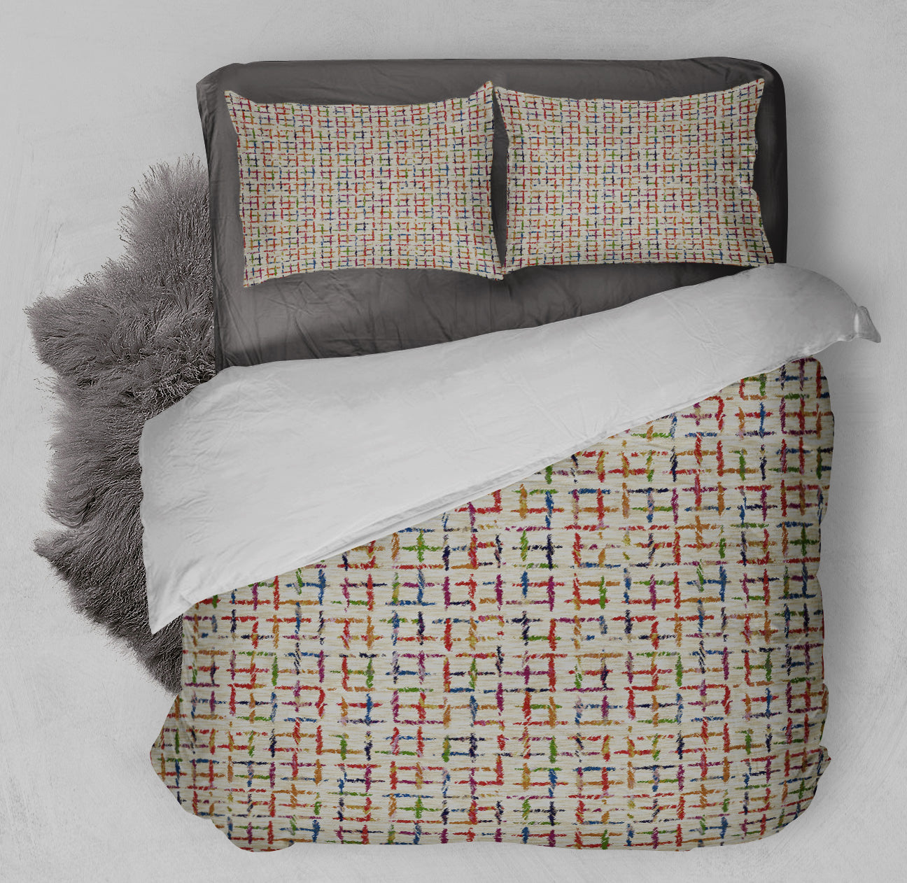 Bed with playful tic tac toe printed duvet cover set and coordinating shag rug.