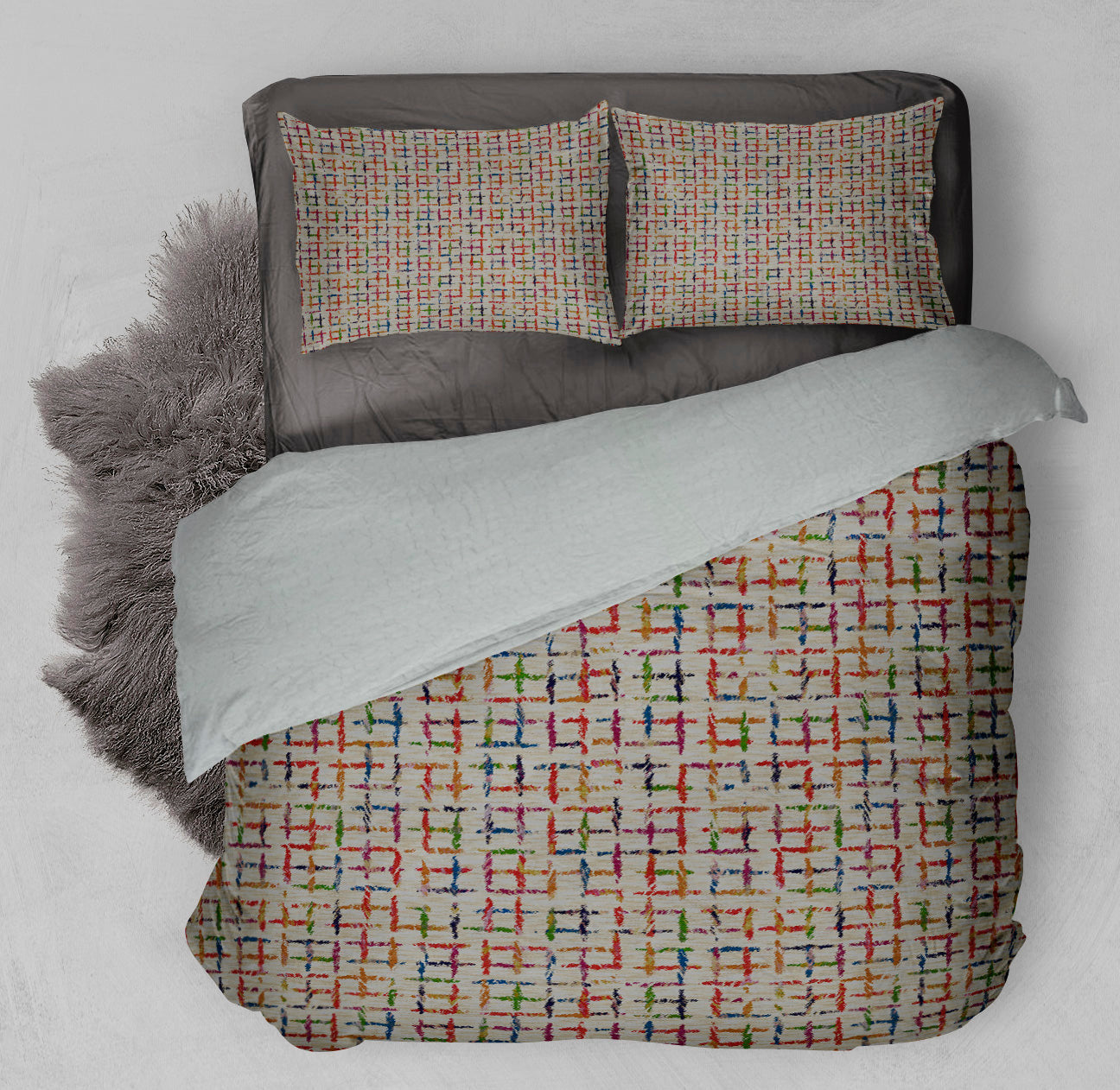 Bed with winter ready Sherpa Comforter Set displaying colorful grid design and complementary shag rug.