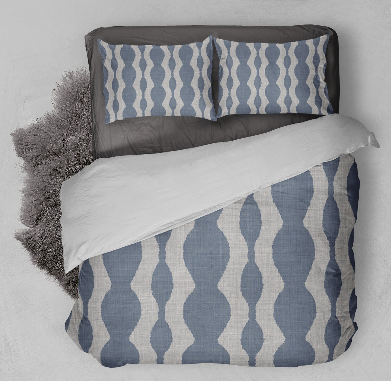 Clean bed featuring printed Comforter Set with delightful chambray colored background and soothing gray wave pattern.