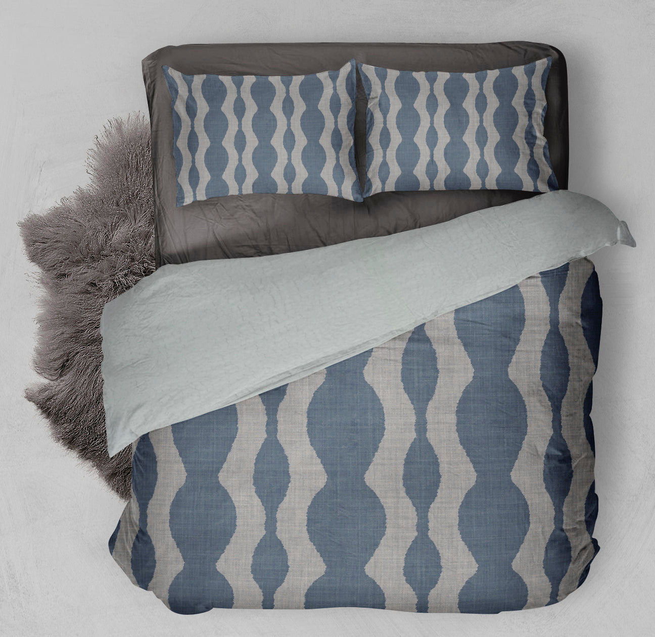 Bed featuring blue winter ready Sherpa Comforter Set displaying gray sonic pattern.