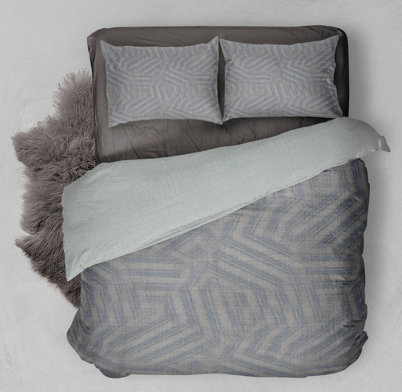 Winter ready bed featuring Sherpa Comforter Set with mesmerizing gray pattern and coordinating shag rug.
