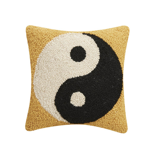 Peaceful accent piece with black and white yin/yang symbol against soft yellow wool fabric