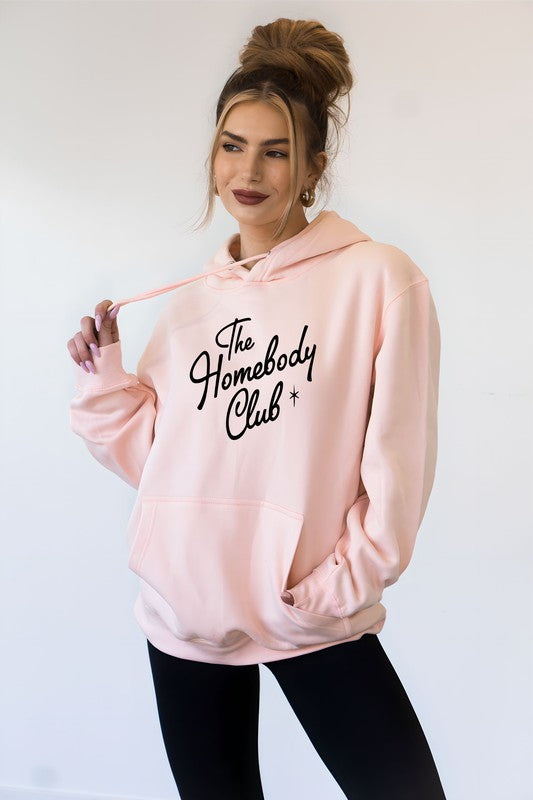 The Homebody Club hoodie in light pink with black font and graphic star