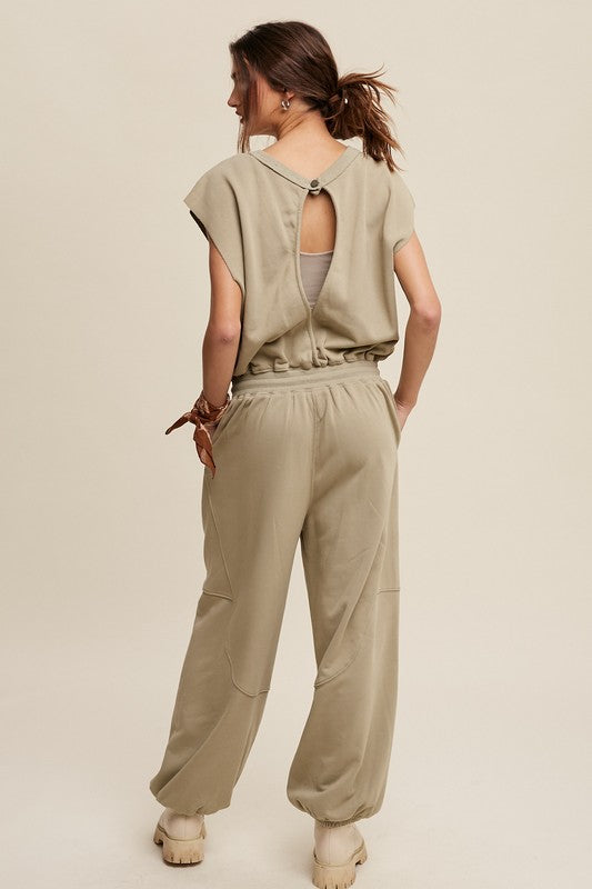 Beige jumpsuit with spandex waistband and keyhole open back for breathable wear.