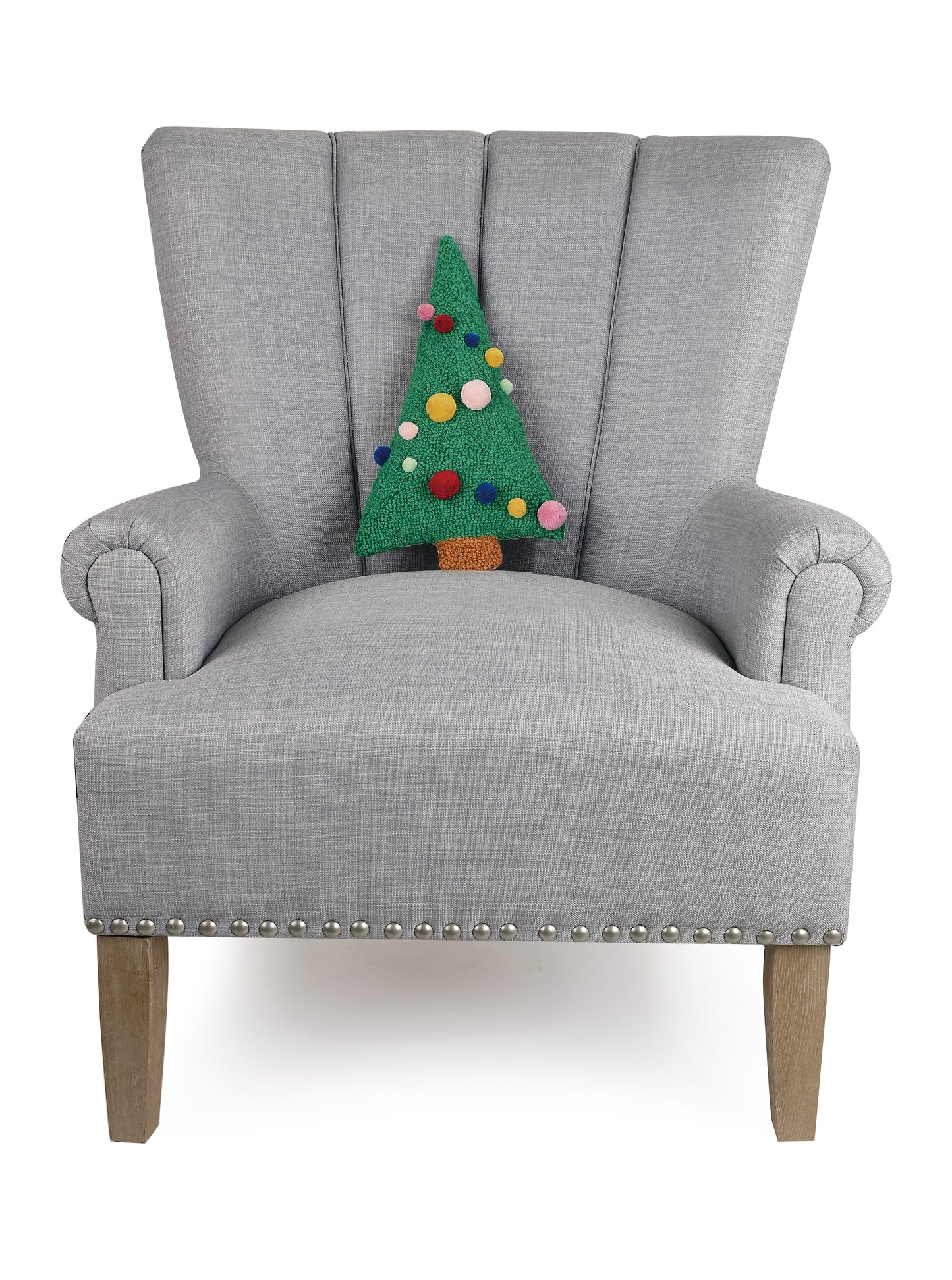 Gray sitting chair displaying mini wool hooked Christmas tree shaped pillow with multicolor 3D pom poms as ornaments 