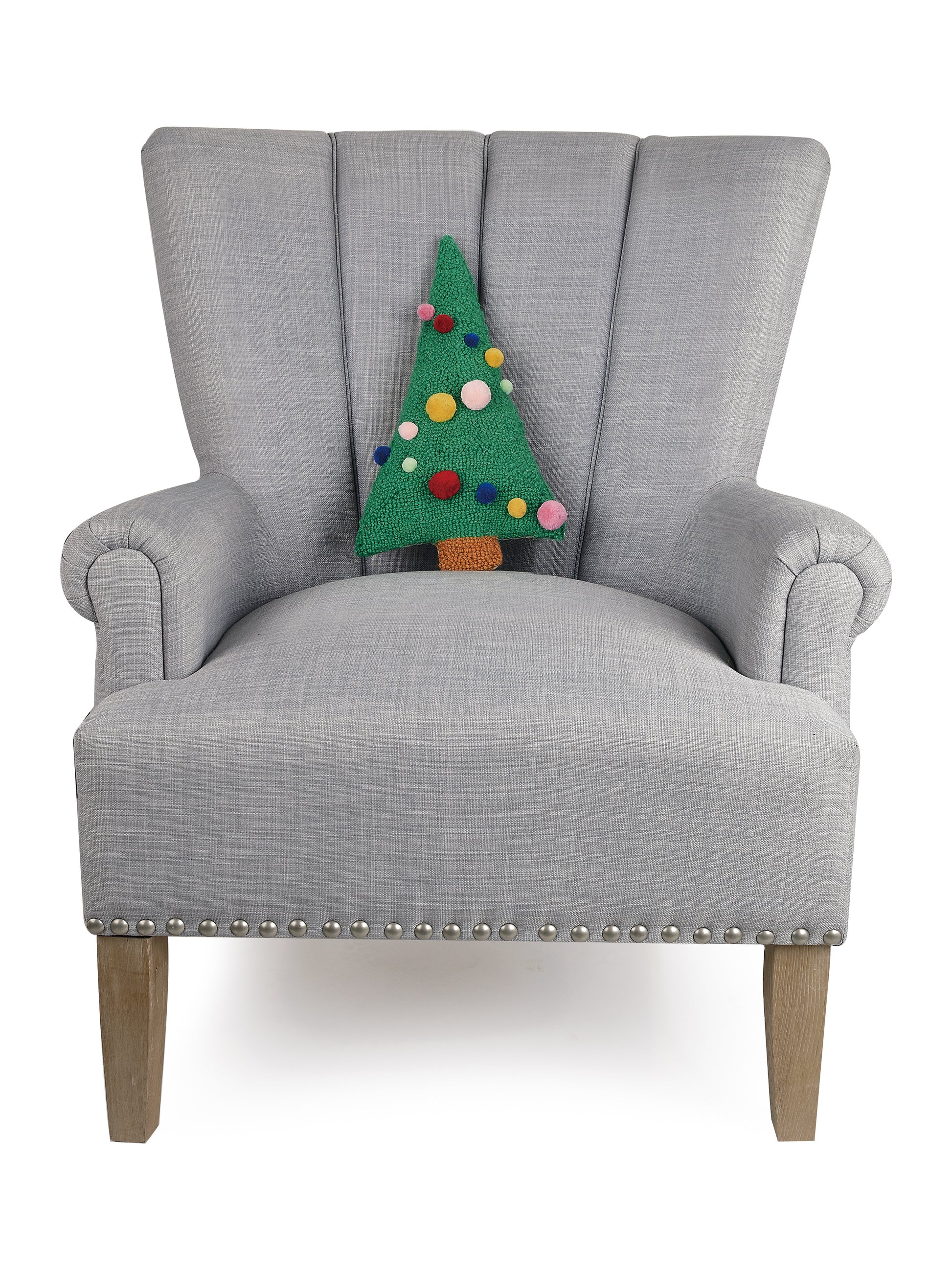 Gray sitting chair displaying mini wool hooked Christmas tree shaped pillow with multicolor 3D pom poms as ornaments 