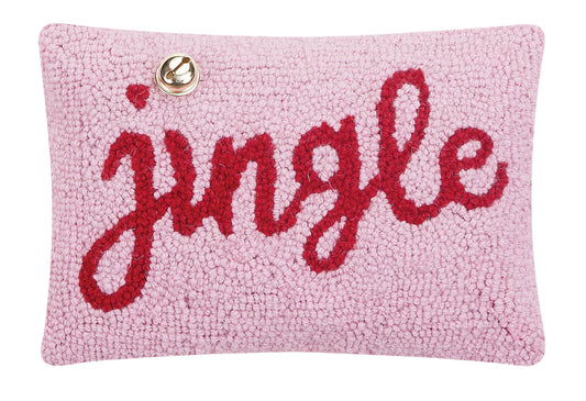 Pink wool hooked pillow that reads “jingle” with red cursive letters and gold bell accent over the “i”