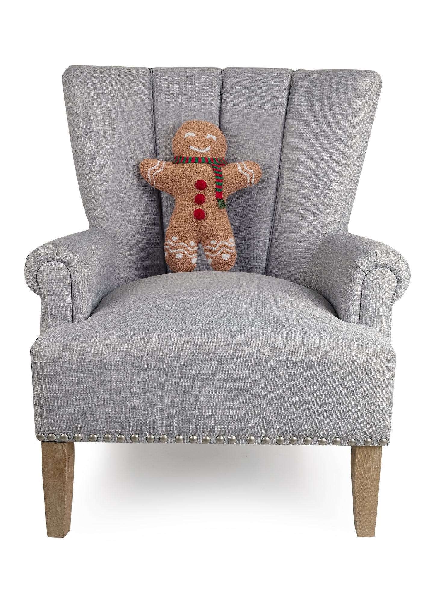 Happy gingerbread man pillow, made of wool, standing 12x16” in gray chair