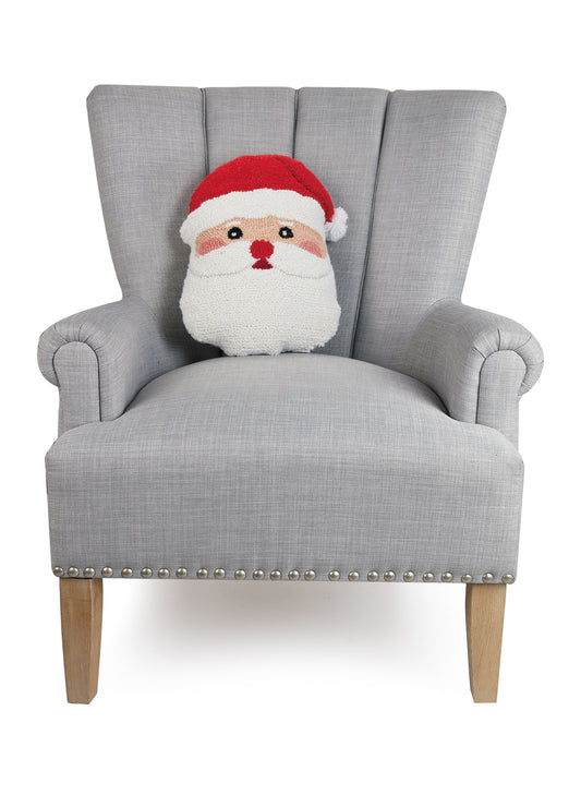 Small wool pillow shaped like Santa’s face styled in gray sitting chair