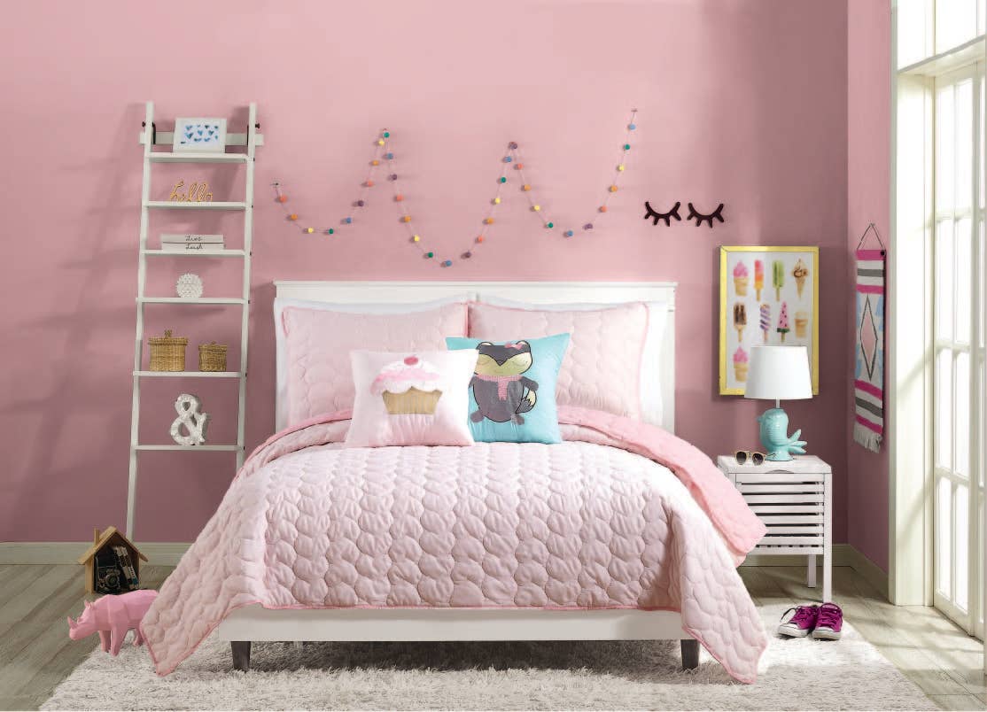 Fun, pink bedroom featuring stitched heart quilt with reversible face.