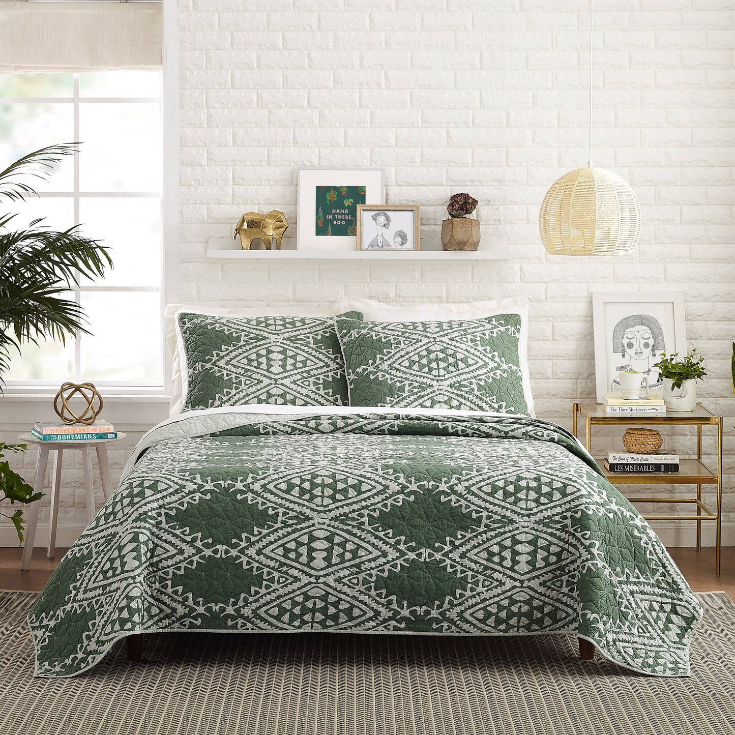 Olive green quilt set with repeating white eclectic, geometric design