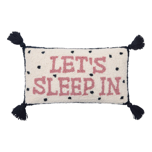 Black and white dotted, tassels novelty pillow with “Let’s Sleep In” pink letters