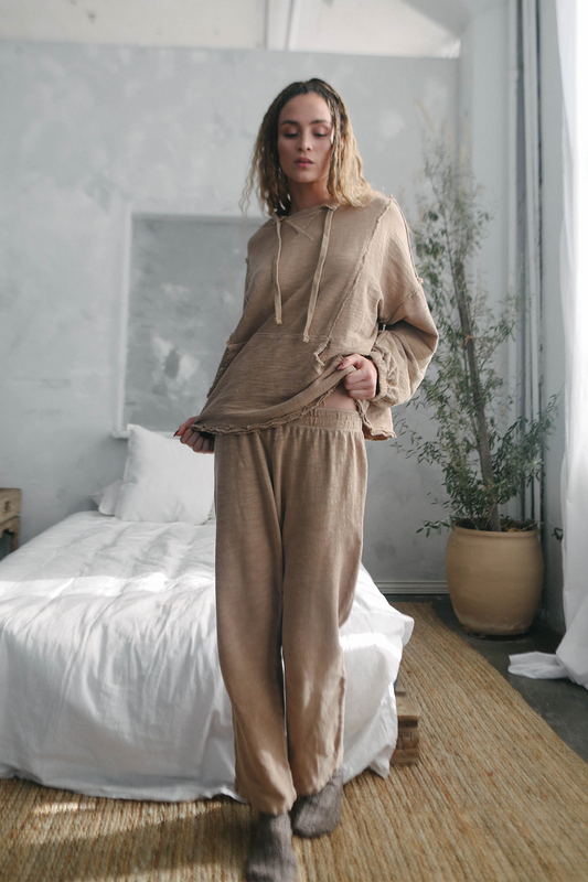 Sustainable relaxed fit pants in sandy earth tone.