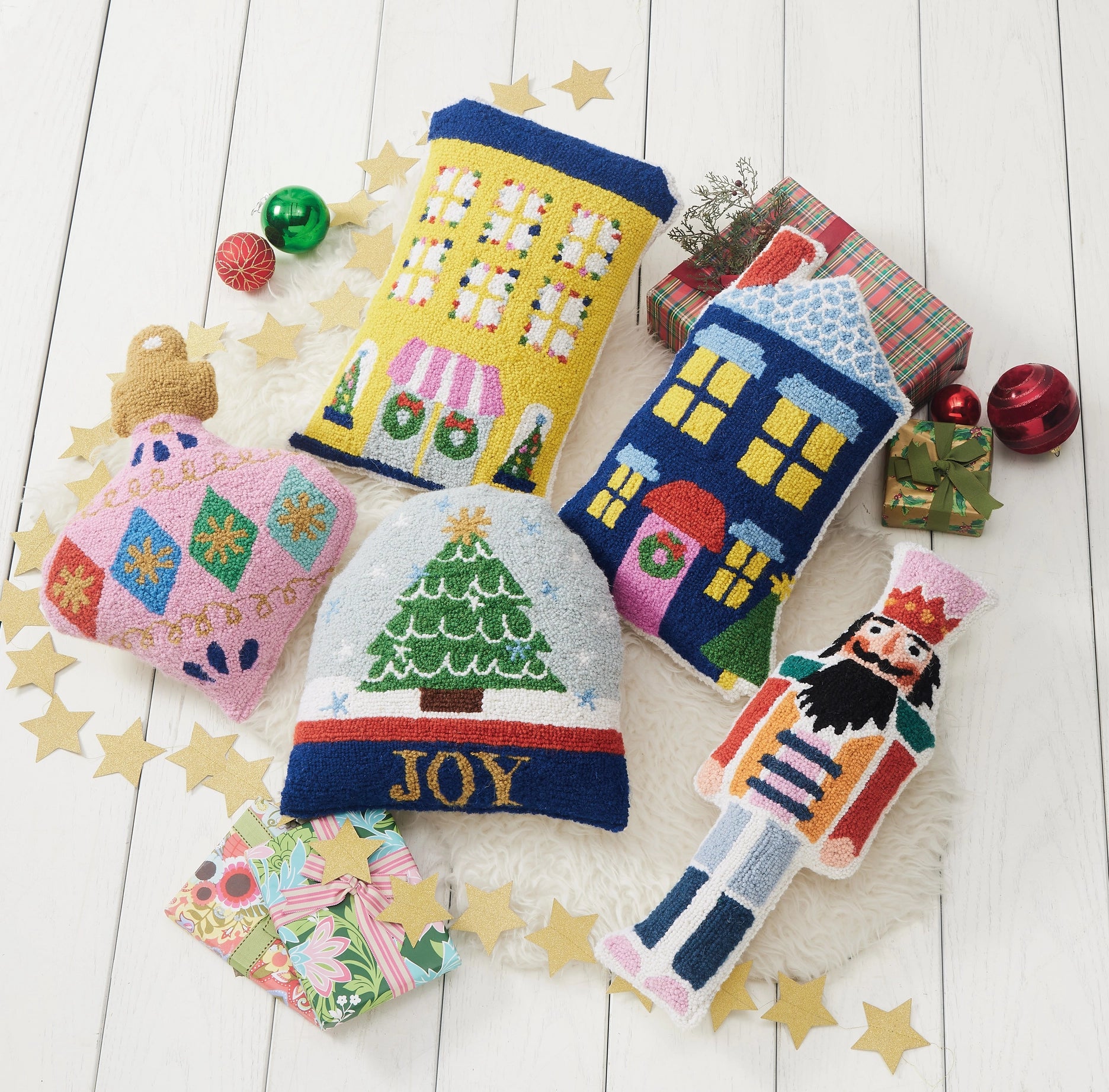 Collection of colorful Christmas holiday shape pillows including the Nutcracker.