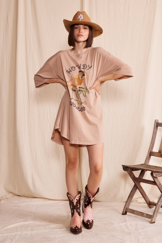 Soft brown, organic cotton, oversized t-shirt dressy with sexy cowgirl graphic and text “howdy partner.”