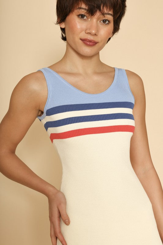 Cream sleeveless mini dress with light blue, navy and red stripes at the top and bottom.