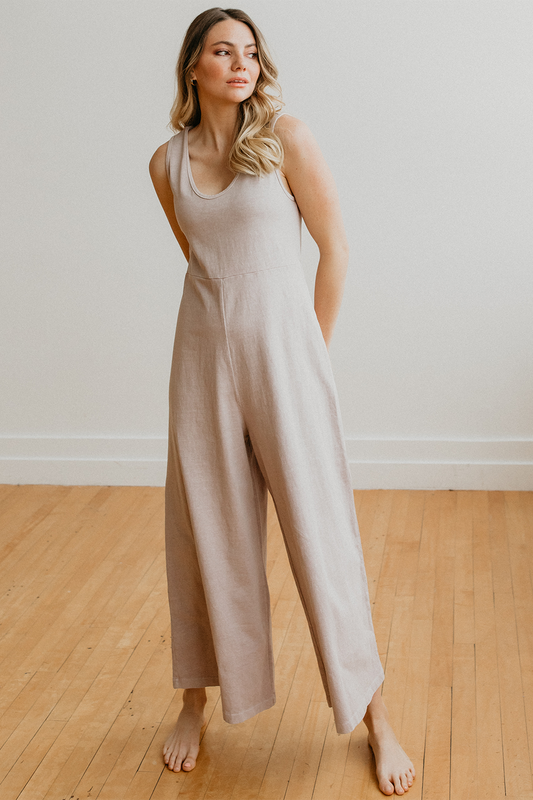 Sleeveless flowy jumpsuit with waist defining seam and wide legs for flexible wear. Fabric is organic cotton in vintage khaki color.