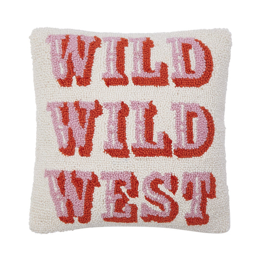 White wool hooked pillow with pink text with orange outline thats reads “WILD WILD WEST”