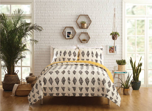 Eclectic room featuring quilt with black dotted diamond design against a cream spread