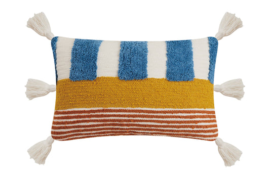 Whimsical, abstract, throw pillow with red and blue stripes throughout adorned with white tassels at each corner