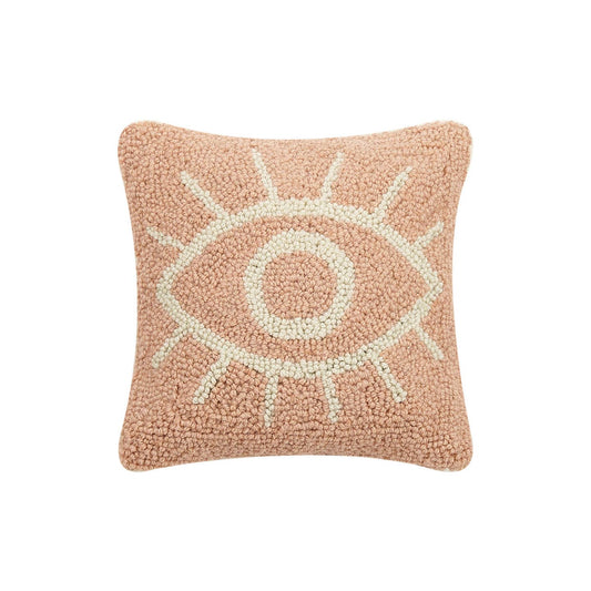 Watching eye throw pillow against soft pink background