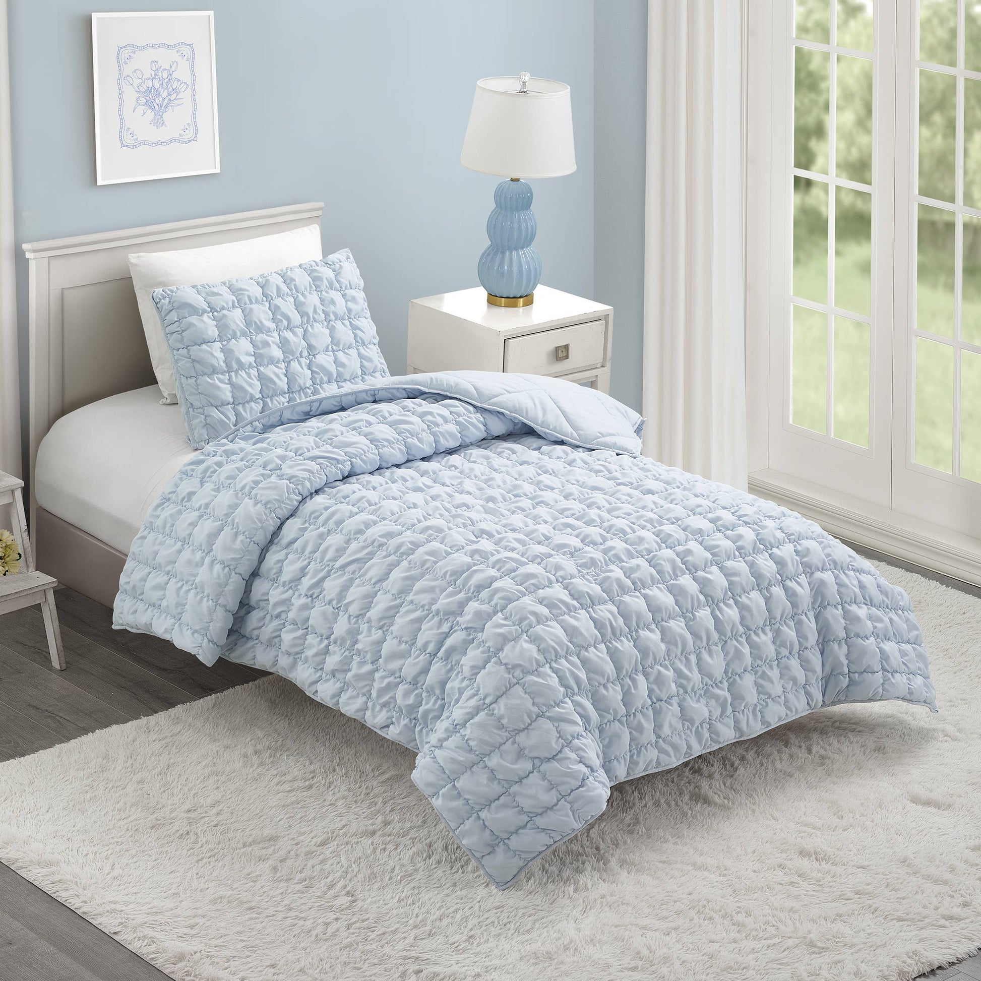 Sky blue cloud-like quilt with puffed polyester fill and channel stitching
