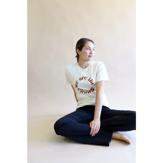 Relaxed Fit Ivory Graphic T-Shirt with brown “we are the change” in circular format
