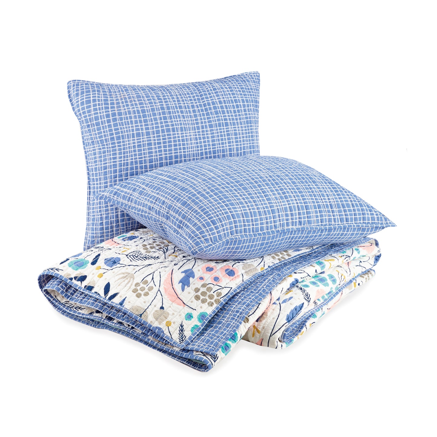 Two pillows atop matching reversible, floral quilt by Elizabeth Olwen.