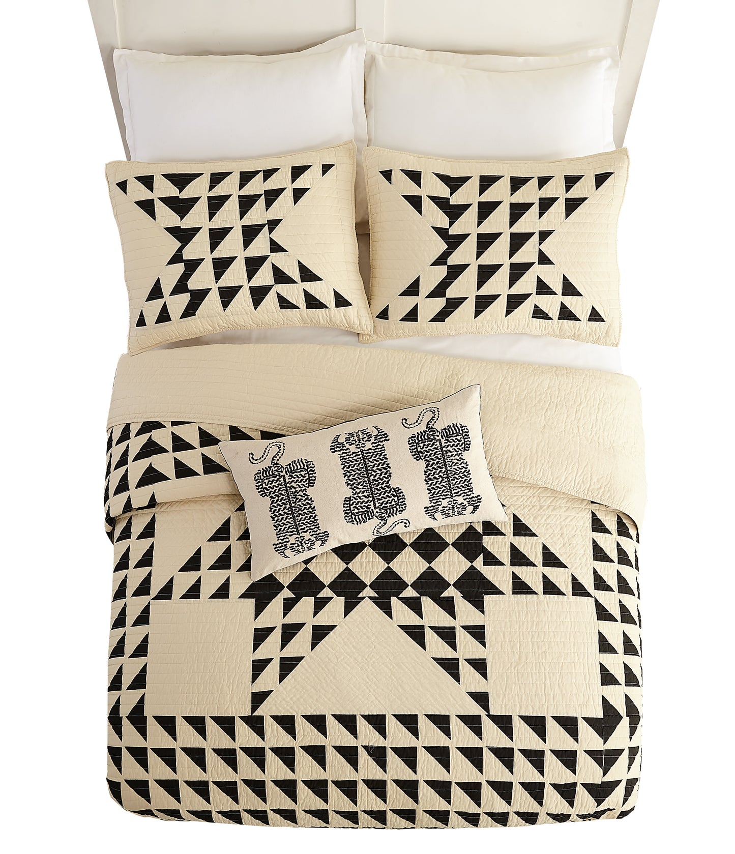 Bedding set featuring geometric, black and ivory quilt with matching pillows by Lemieux Et Cie