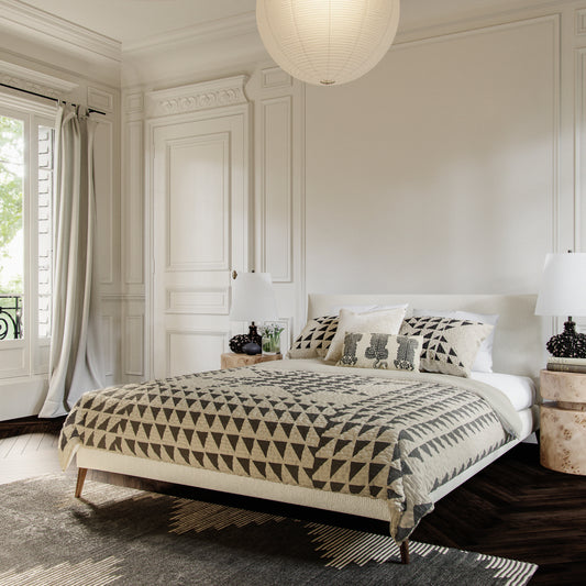 Traditional style bedroom featuring geometric, black and ivory quilt set by Lemieux Et Cie