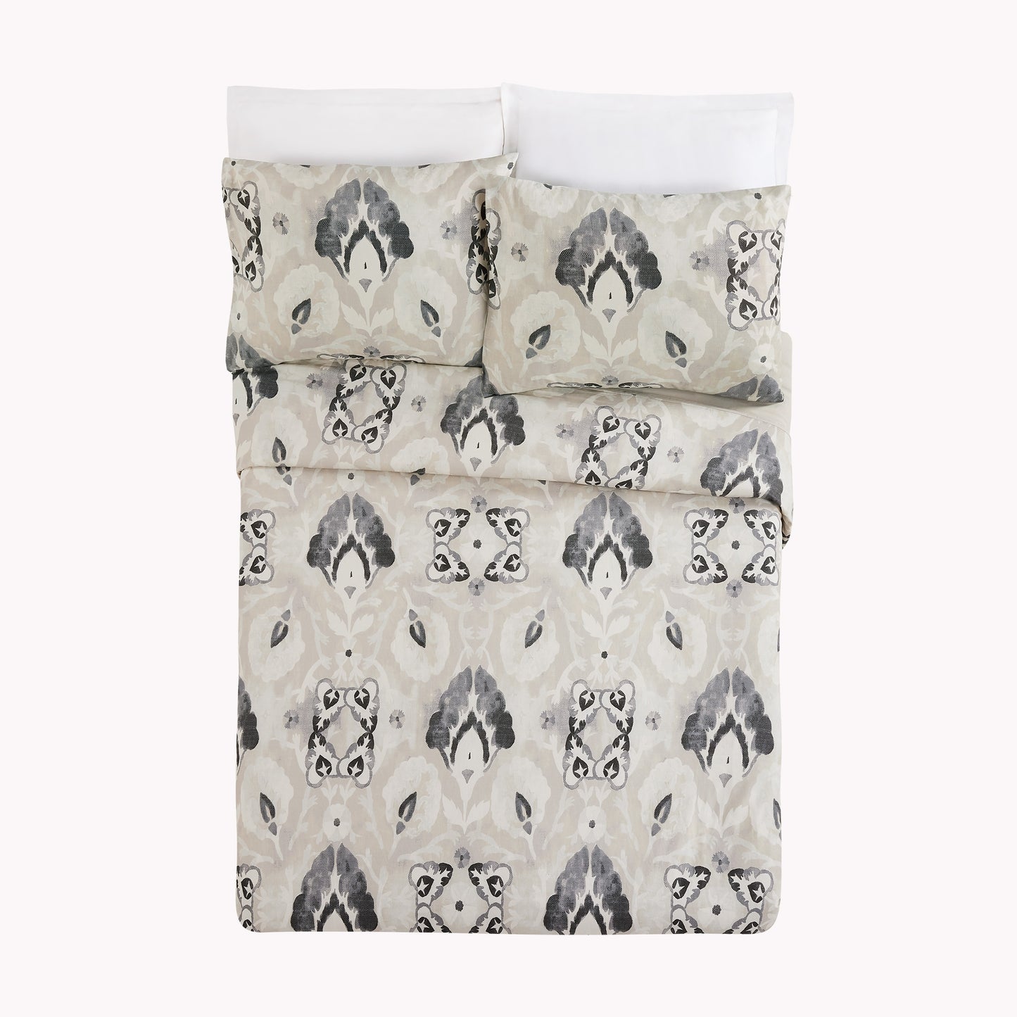 Bed with black, gray and cream floral motif duvet bedding set by Lemieux Et Cie.