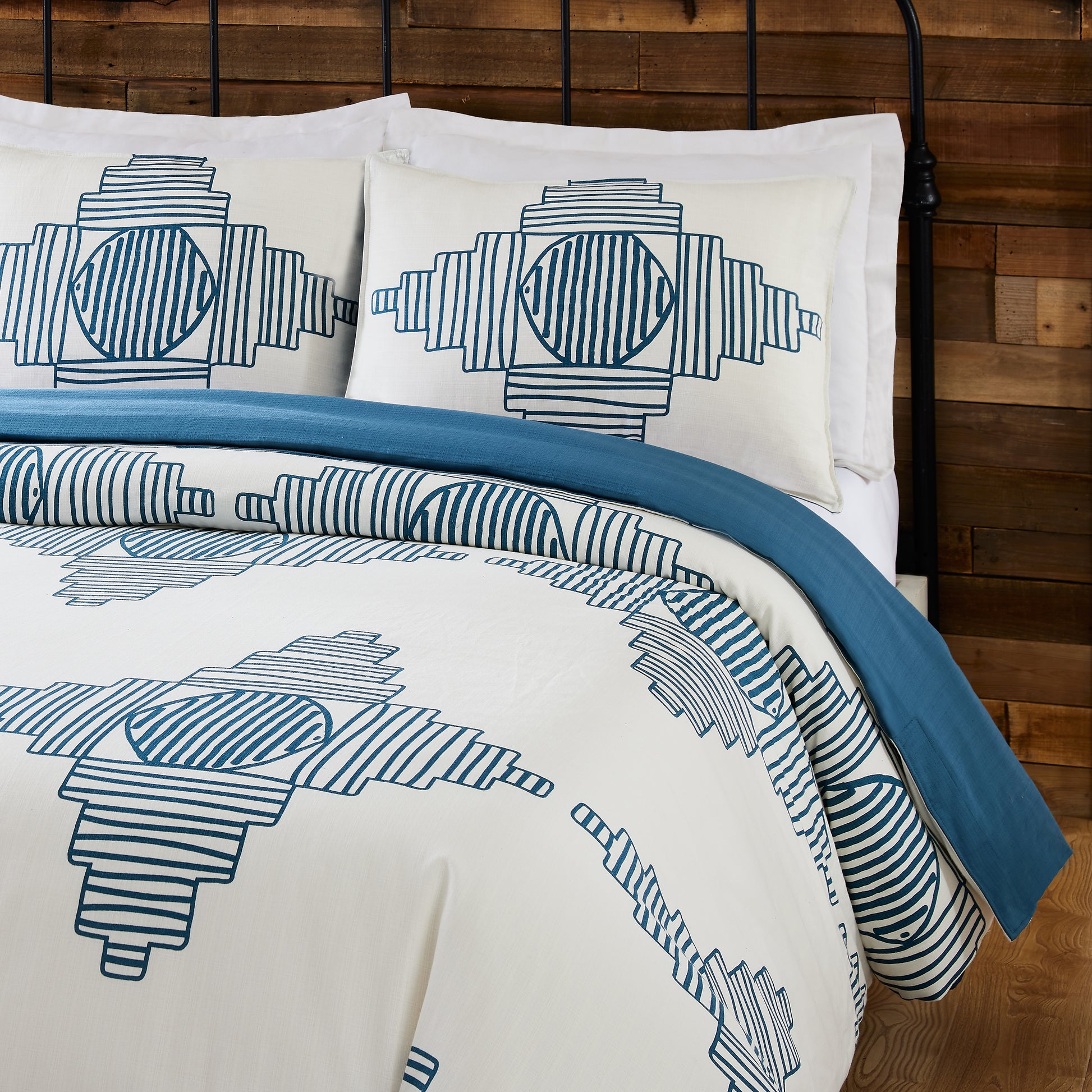 Close up of Justina Blakeney reversible duvet cover set with abstract, turquoise and white pattern