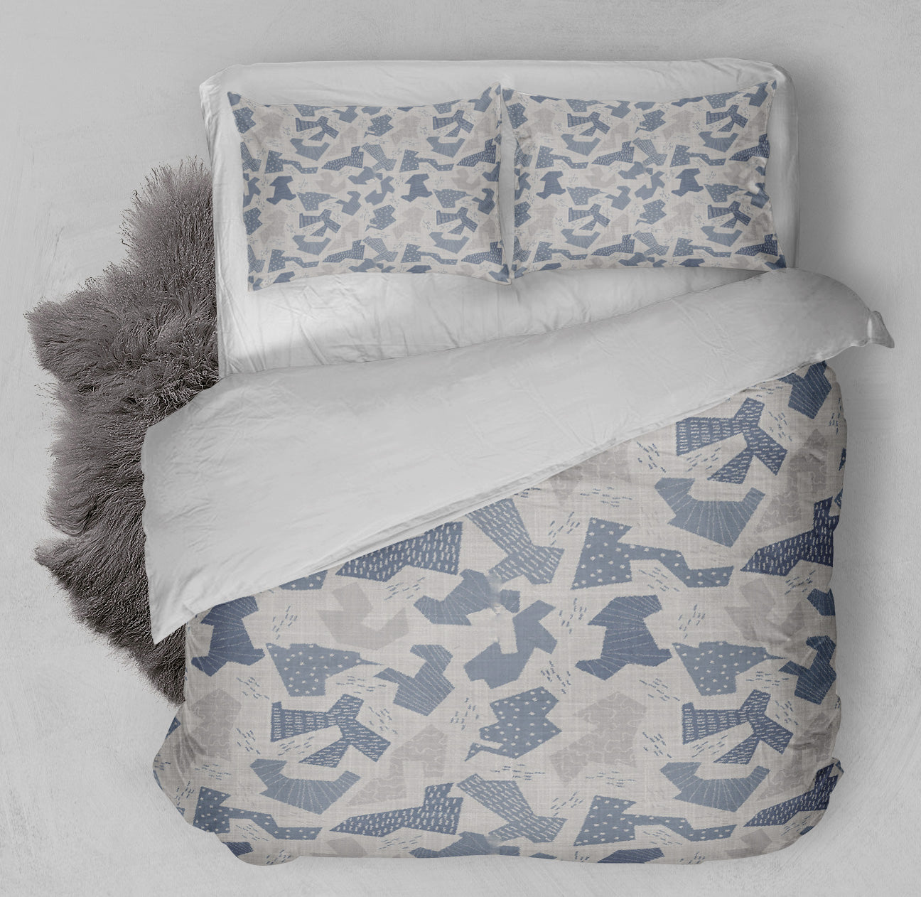 Made up bed displaying printed gray Comforter Set with blue and gray abstract camo shapes.