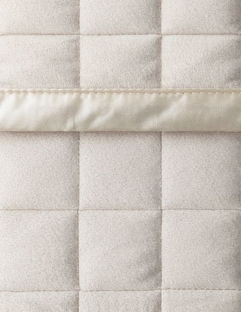 Close up Luxus Angel Velvet Quilt, in ivory, with boxed embroidery and satin edge.