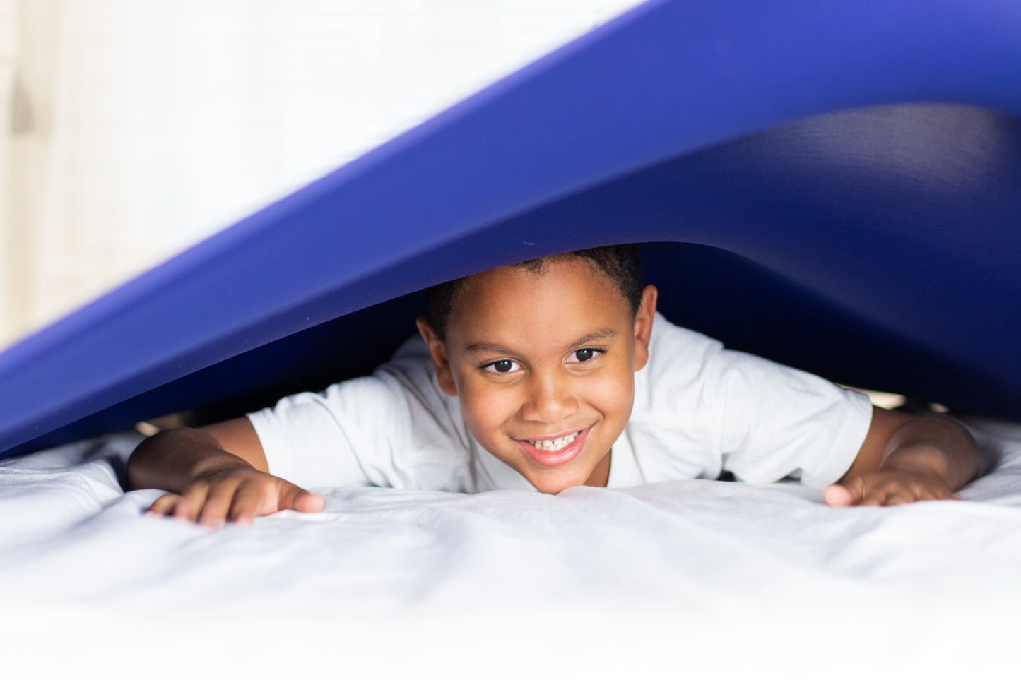 Boy enjoy comfort under blue compression bed sheet 