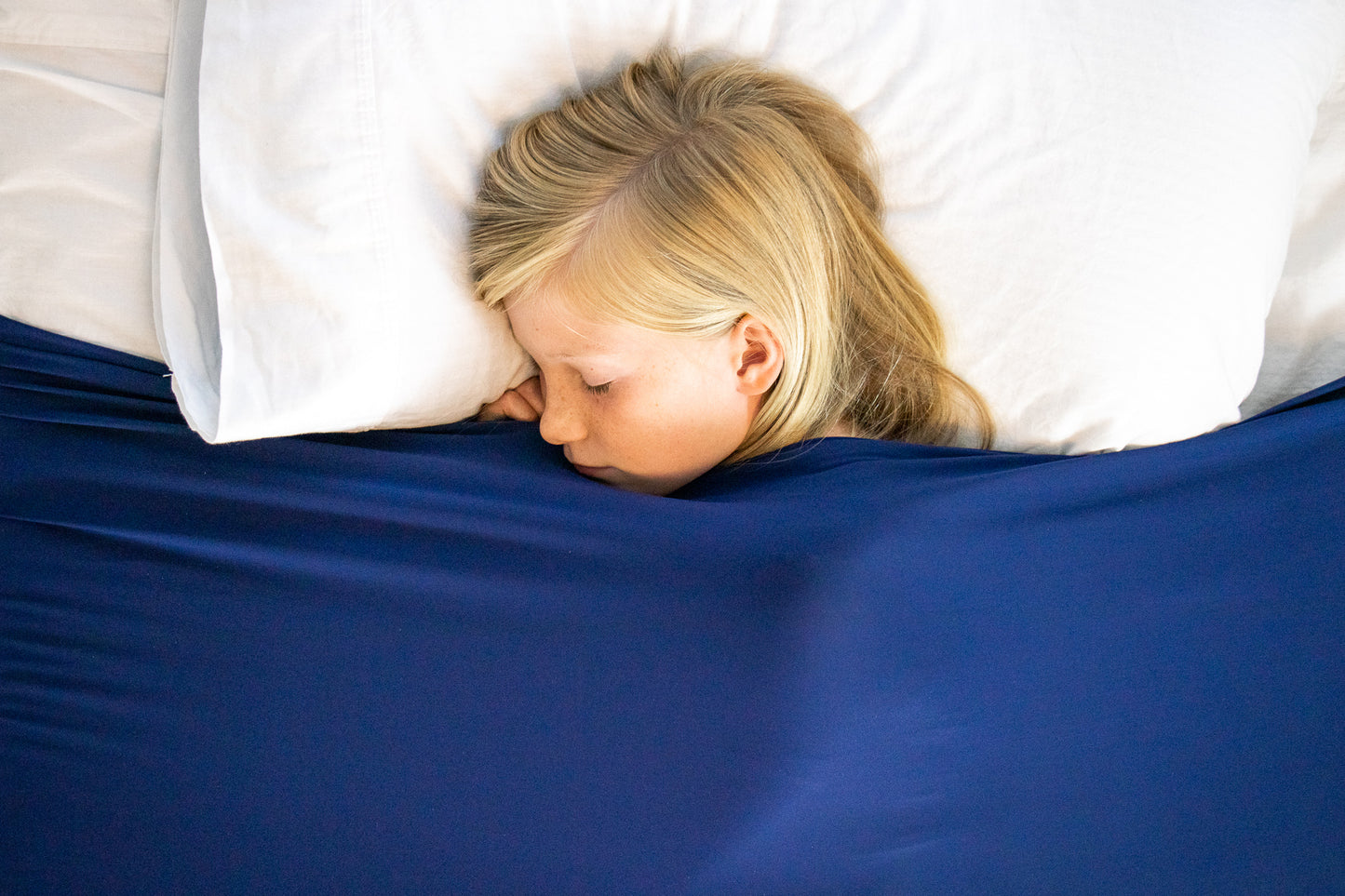 Young girl sound asleep under Cozy Compression Bed Sheet