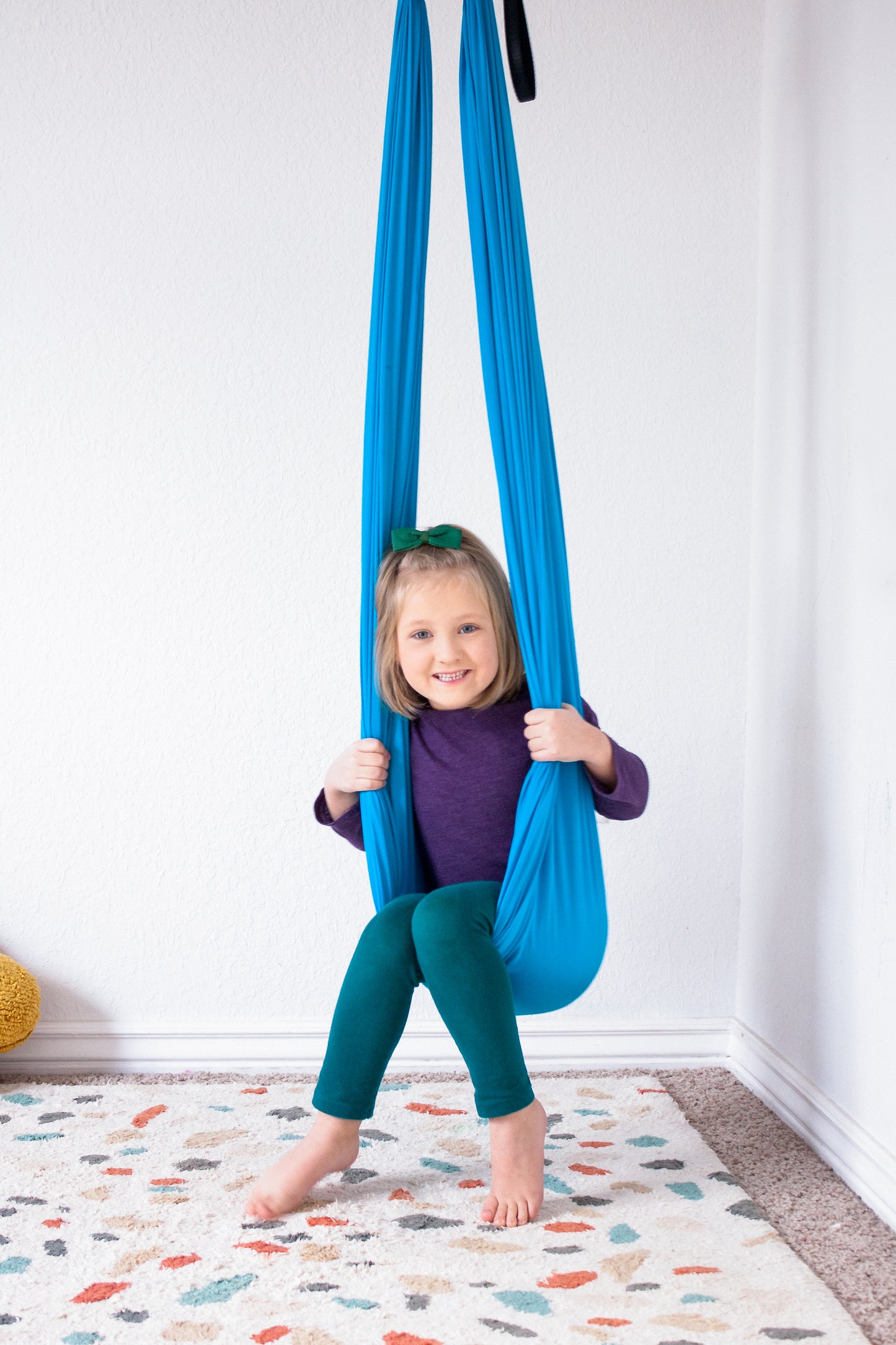 Young girl enjoying compression therapy swing.