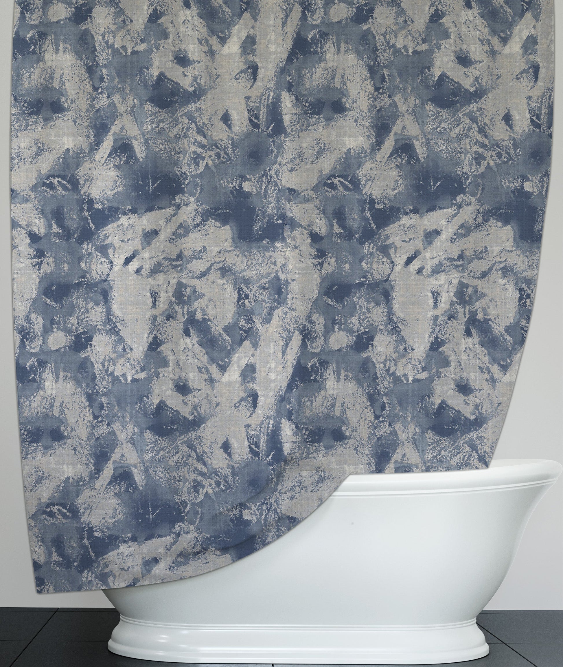 Shower curtain, hanging over freestanding bathtub, featuring refreshing washable shower curtain with blue and white abstract design.