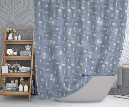 Modern bathroom featuring printed shower curtain with blue and white geometric pattern.