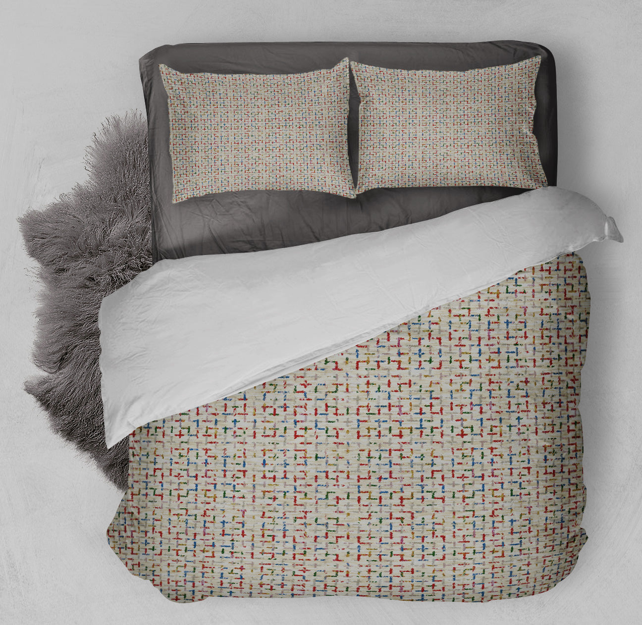 Cozy bed featuring printed comforter set with colorful Tetris design and coordinating shag rug.